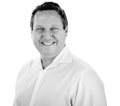 Portrait of James Montgomery, Chief Product Officer of Manufacturo, wearing a white collared shirt and smiling.