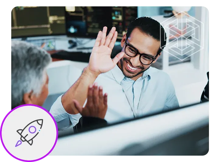 Two smiling manufacturing professionals high-fiving in an office. A stylized rocket icon is in the lower left corner.