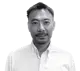Headshot of Kenzo Takai, Chief Operations Officer, wearing a white button-down shirt. He has short, dark hair and a goatee.